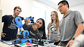 Dr. Longfei Zhou observing students working on 3D project