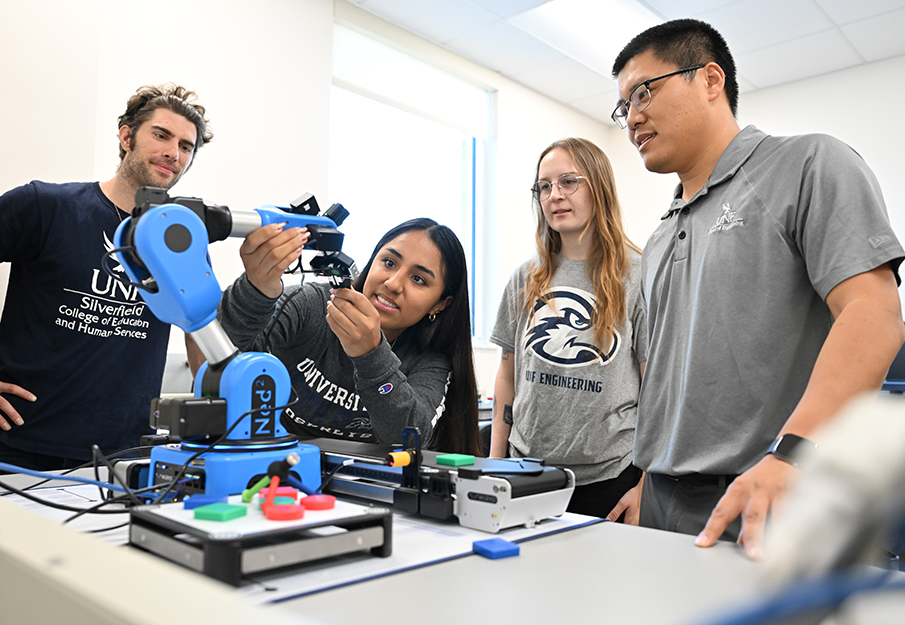 Dr. Longfei Zhou observing students working on 3D project