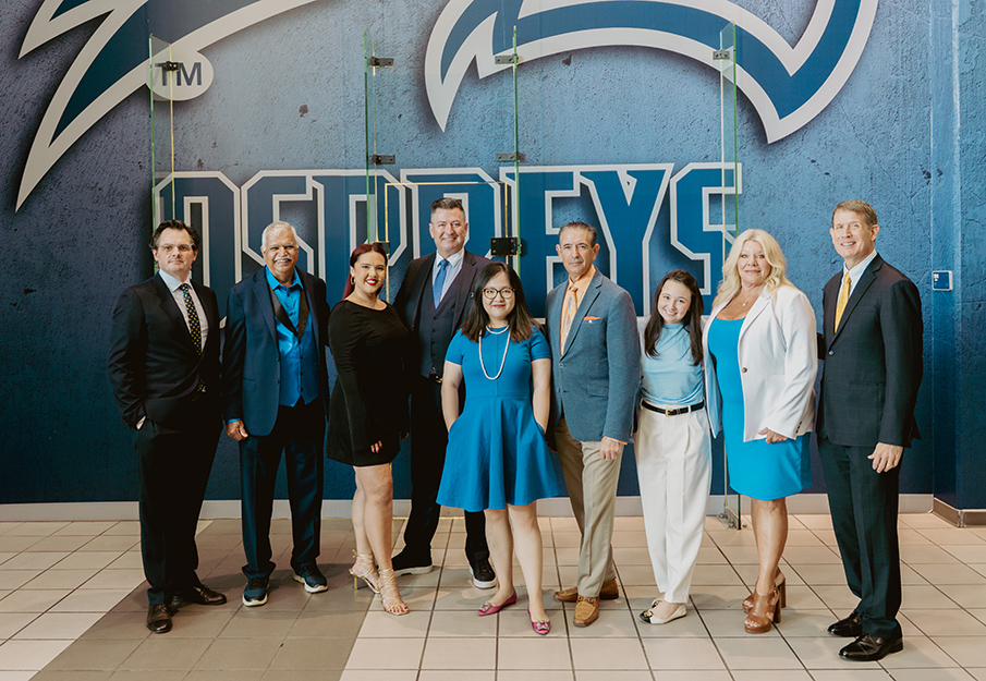 BCH faculty and Arthur Murray International staff posing in front of Osprey logo