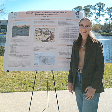 Sarah Lee Boyd standing next to poster presentation