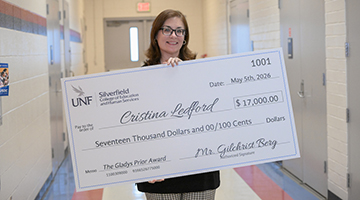 Cristina Ledford holding her Gladys Prior check