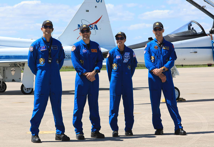Delaney and NASA team standing in front jet