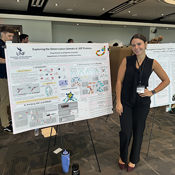 Erina Kotreli standing next to her project presentation board
