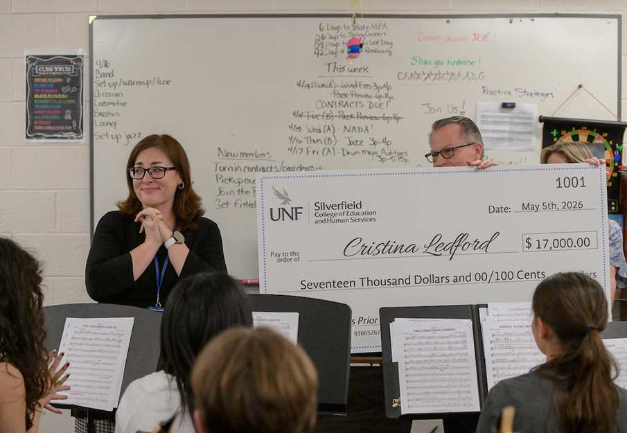 Cristina Ledford being handed her Gladys Prior check
