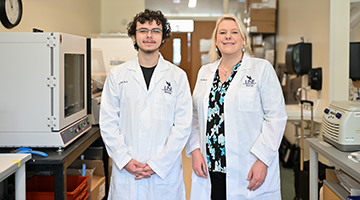 Cameron Hartmoyer and Dr. Terri Ellis standing beside each other in Biology lab