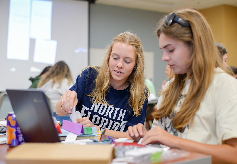 UNF student sitting next to a Duval student