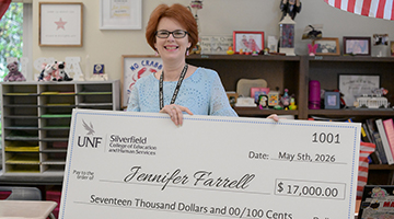 Jennifer Farrell holding her Gladys Prior check