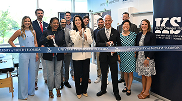 UNF Interim President Dr. Angela Garcia Falconetti, BCH faculty and Korey Stringer Institute staff cutting blue ribbon