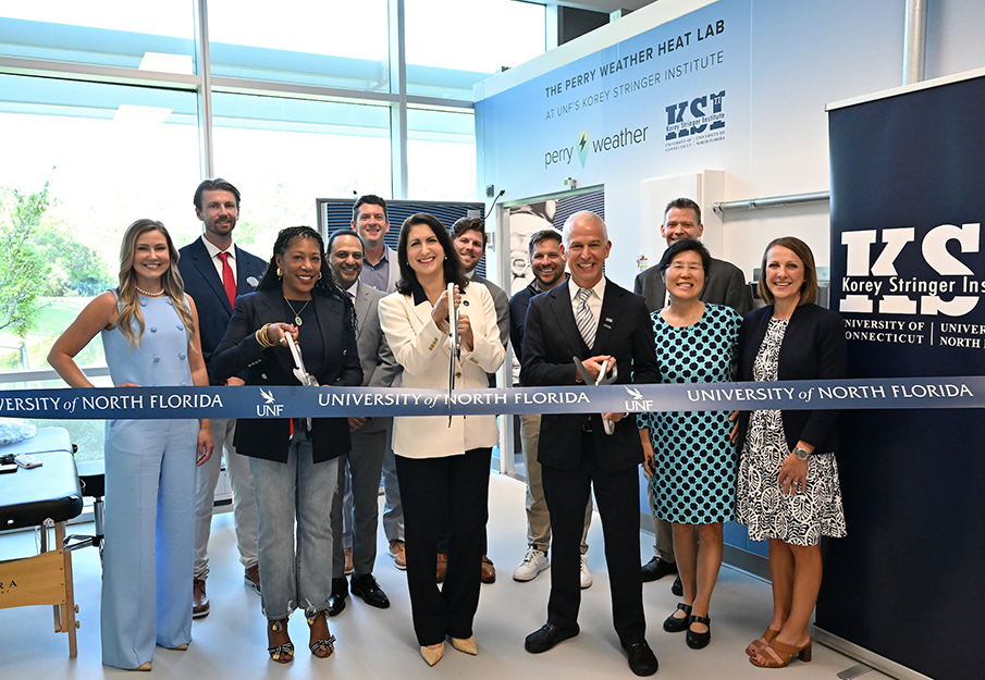 UNF Interim President Dr. Angela Garcia Falconetti, BCH faculty and Korey Stringer Institute staff cutting blue ribbon