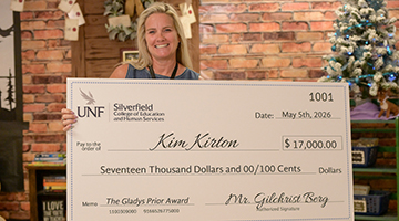 Kim Kirton holding her Gladys Prior check