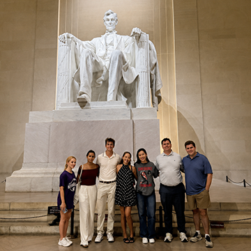 Seven UNF faculty and students in front of Lincoln Memorial