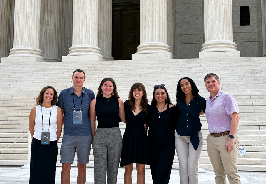 Seven UNF faculty and students in front of Washington, D.C. monument