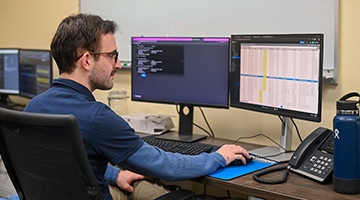 Alex Ramudo working at two monitors