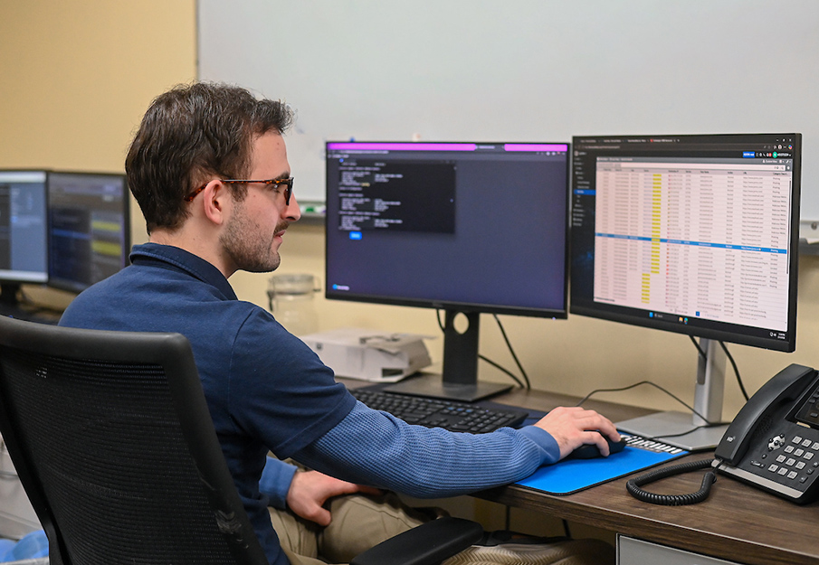 Alex Ramudo working at two monitors