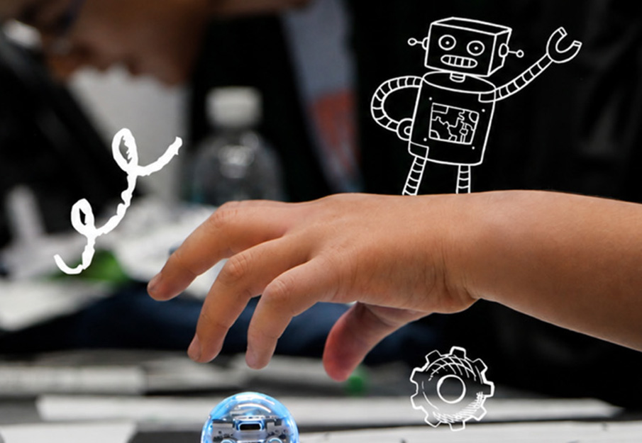 Child's hand reaching for a building block, a drawing of a robot and gear float around the hand