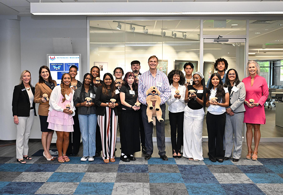 Dr. Paul Schilling standing with group of UNF staff and students