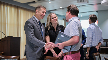 Dr. Michael P. Shannon shaking hands at faculty and staff forum