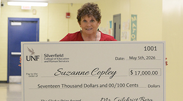 Suzanne Copley holding her Gladys Prior check