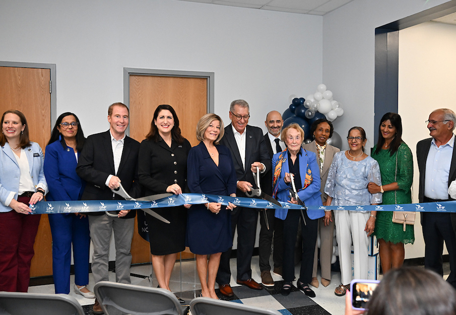 UNF Interim President Angela Falconetti, UNF faculty, students and donors cutting ribbon