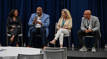 Samantha Vance, Ervin Lewis, Tammie Talley and Alex Alston sitting on platform with microphones in hands