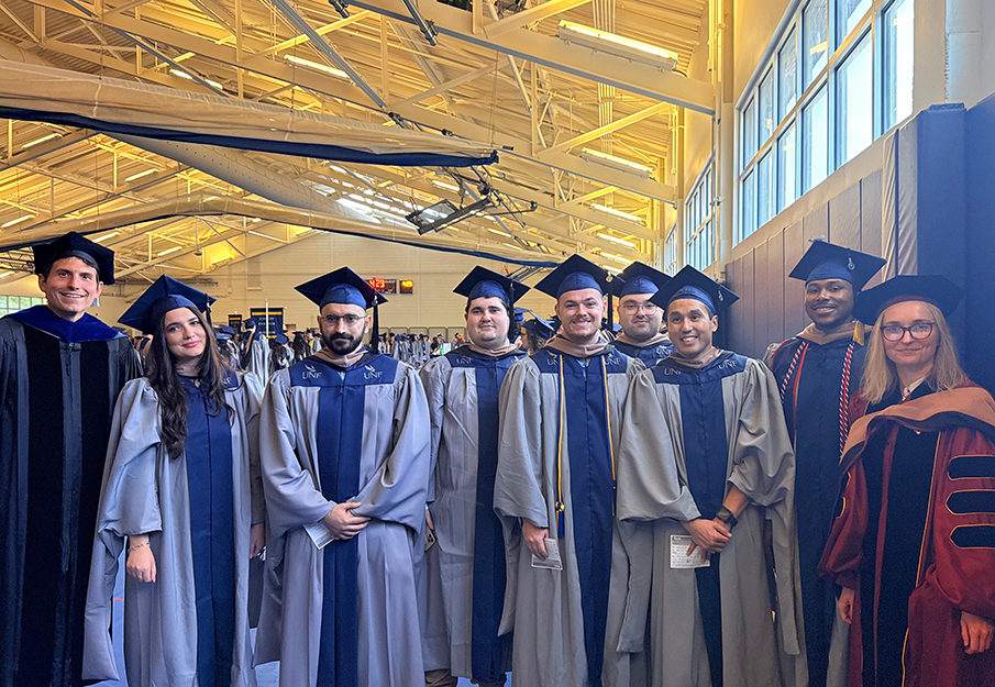 First FinTech graduating cohort standing together in their caps and gowns