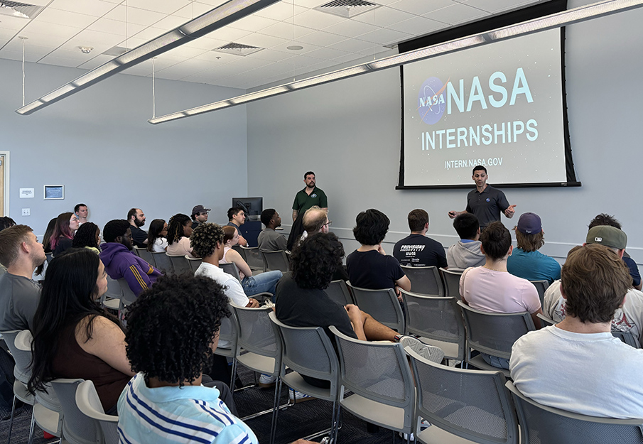 UNF alum Joseph Maldonado and NASA Outreach Jarrod Bales talking to a room full of UNF students