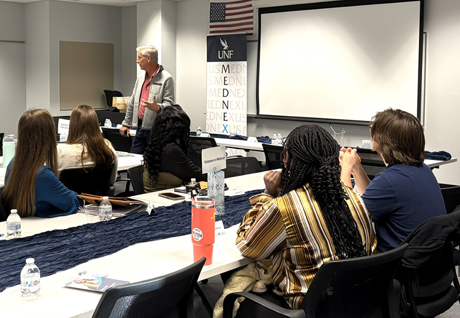 UNF MedNexus students listening to a lecturer in classroom