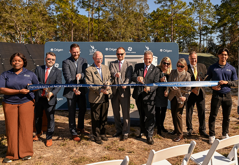 UNF President Moez Limayem and representatives cutting ribbon
