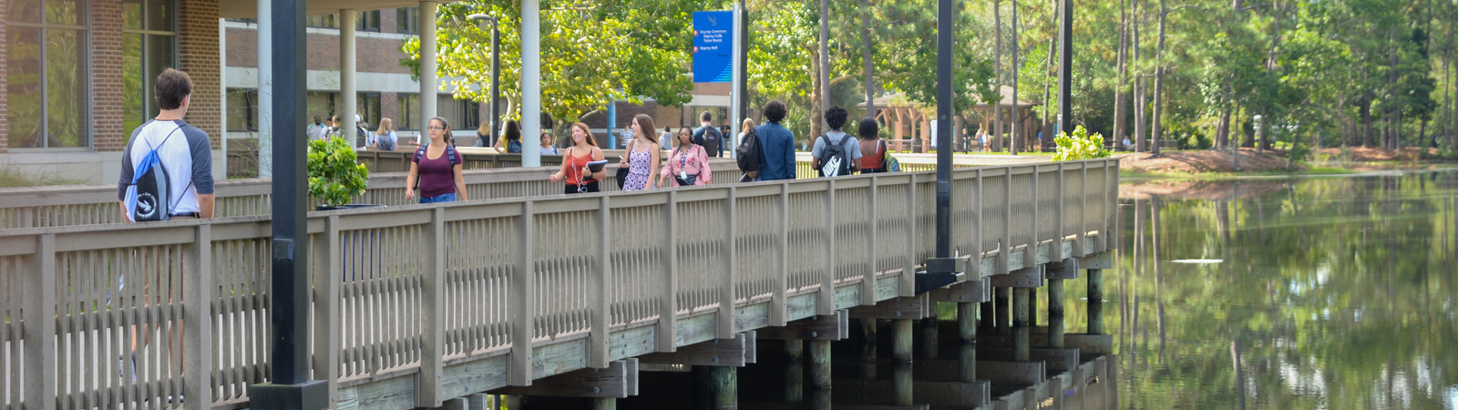 Students walking across the bridge near the cafe