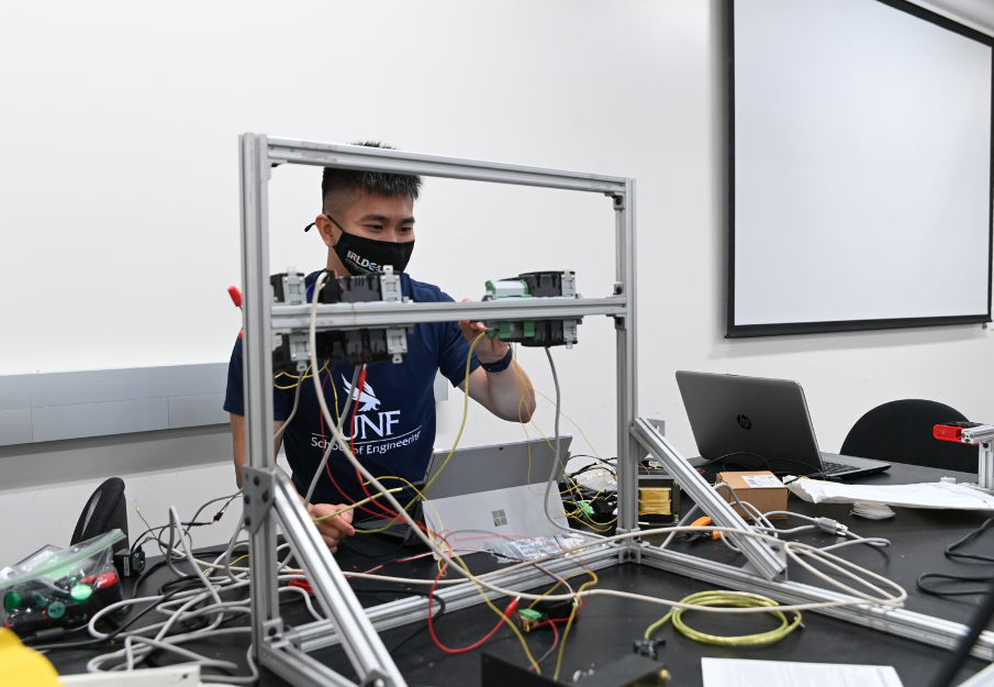 Engineering student in a lab using equipment