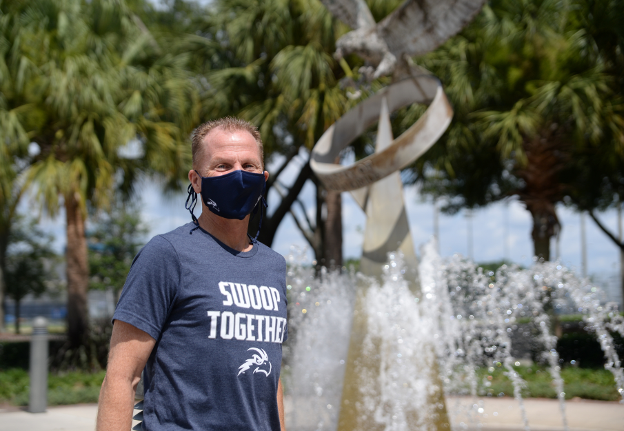 Coach Driscoll wearing mask by fountain
