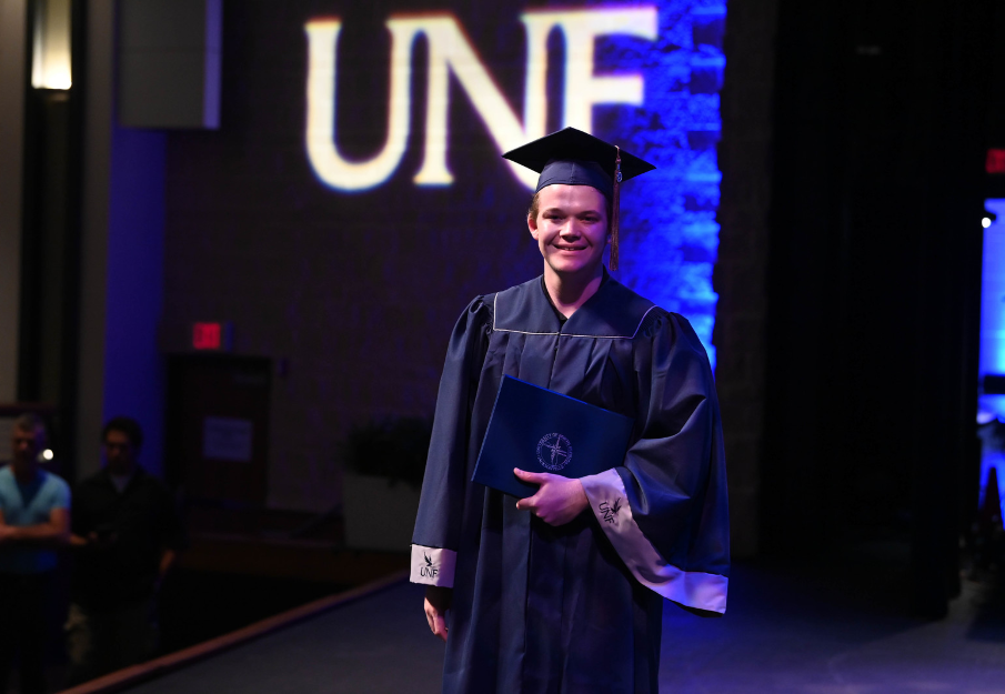 UNF Student walking at commencement
