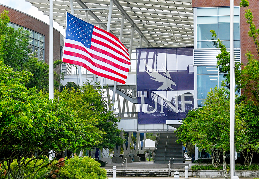 American flag at half mast in the UNF Veterans Plaza