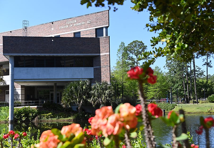 Campus building with flowers in the foreground