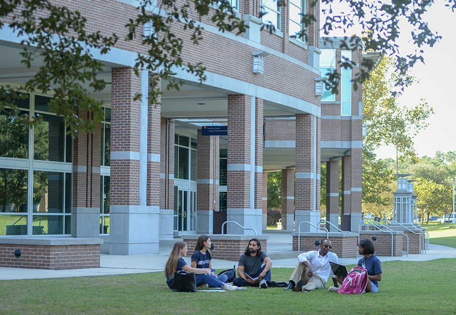 Students sitting and talking on the green