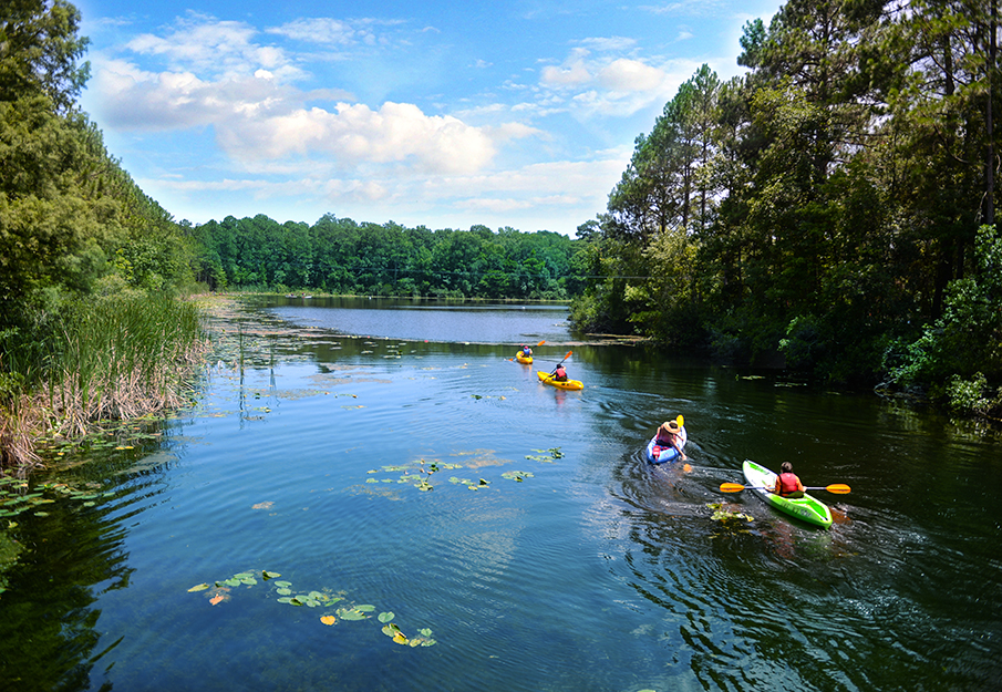 students kayak lake
