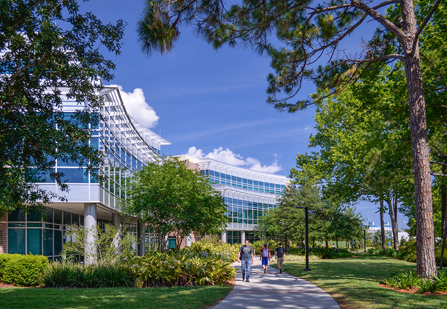 View of the COEHS building with a pond in front