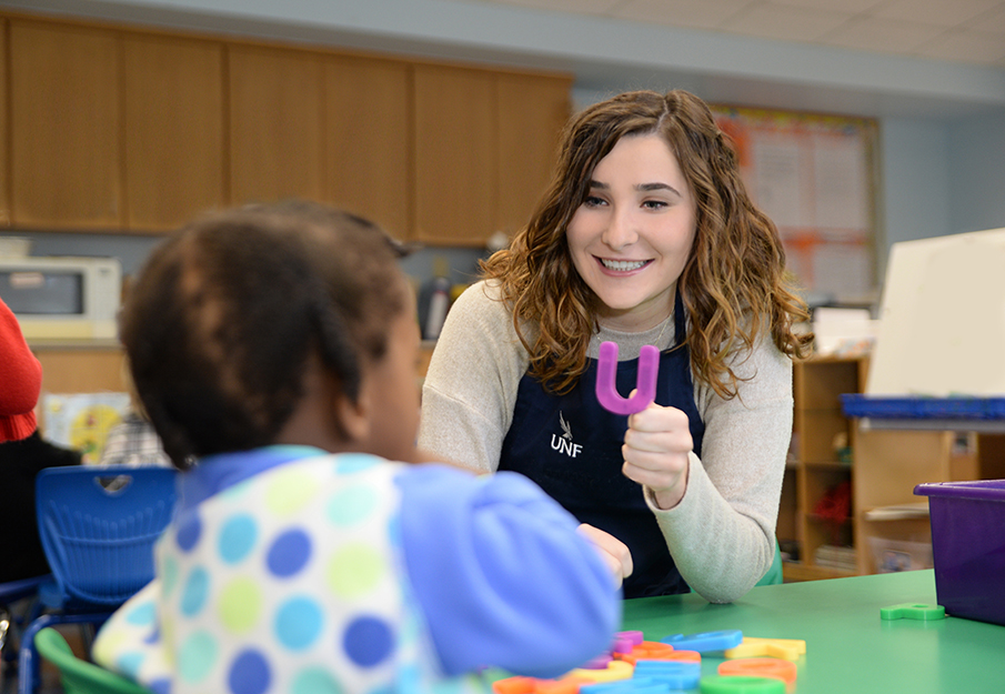 UNF preschool educator teaching students in a classroom.