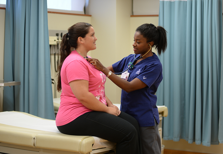 Nurse helping female patient
