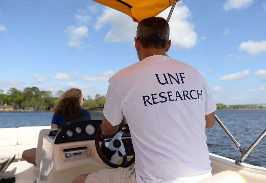 UNF researchers on a boat