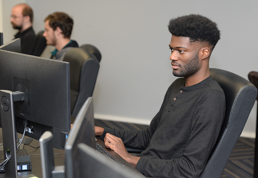 Male student using a desktop computer in the UNF Computer Lab