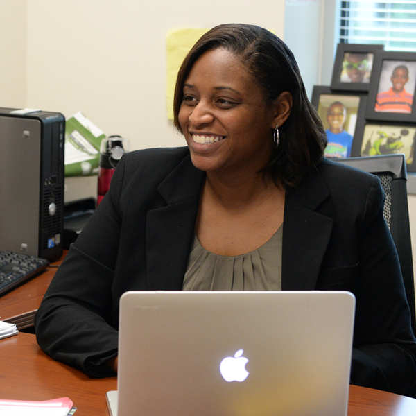 faculty member on laptop