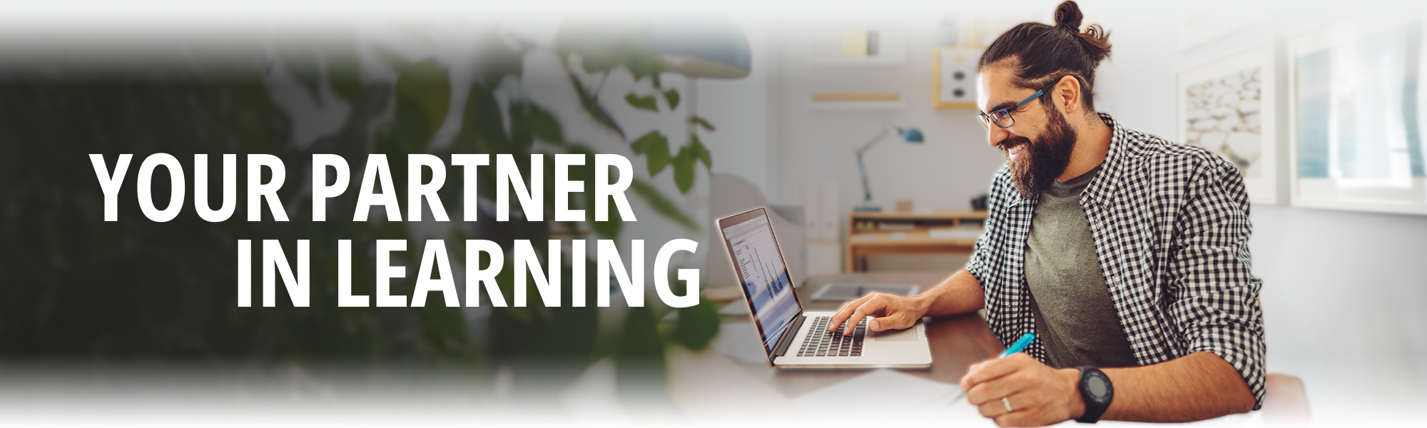 Your Partner in Learning, man working on laptop