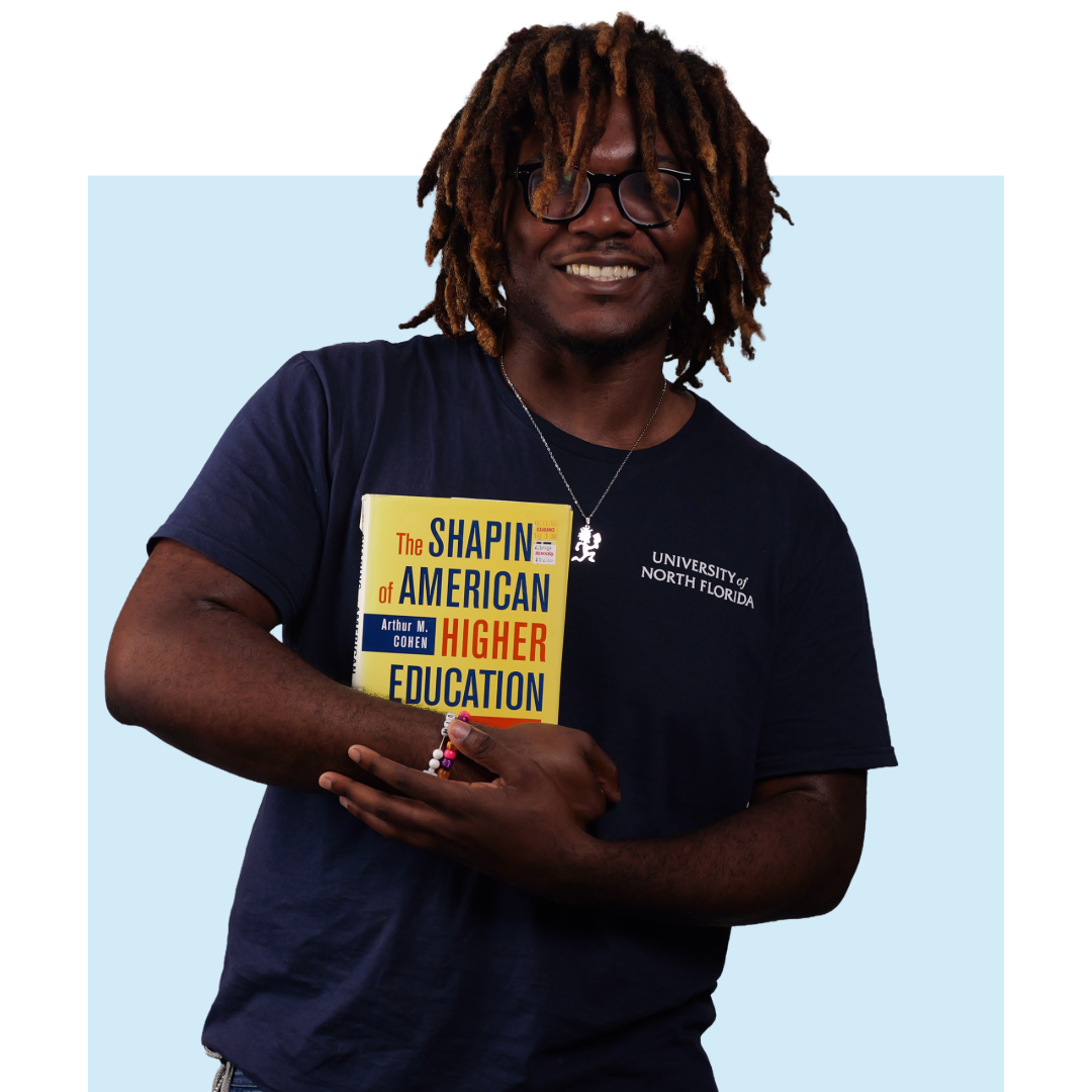 Adrian Onyeukwu holding book headshot