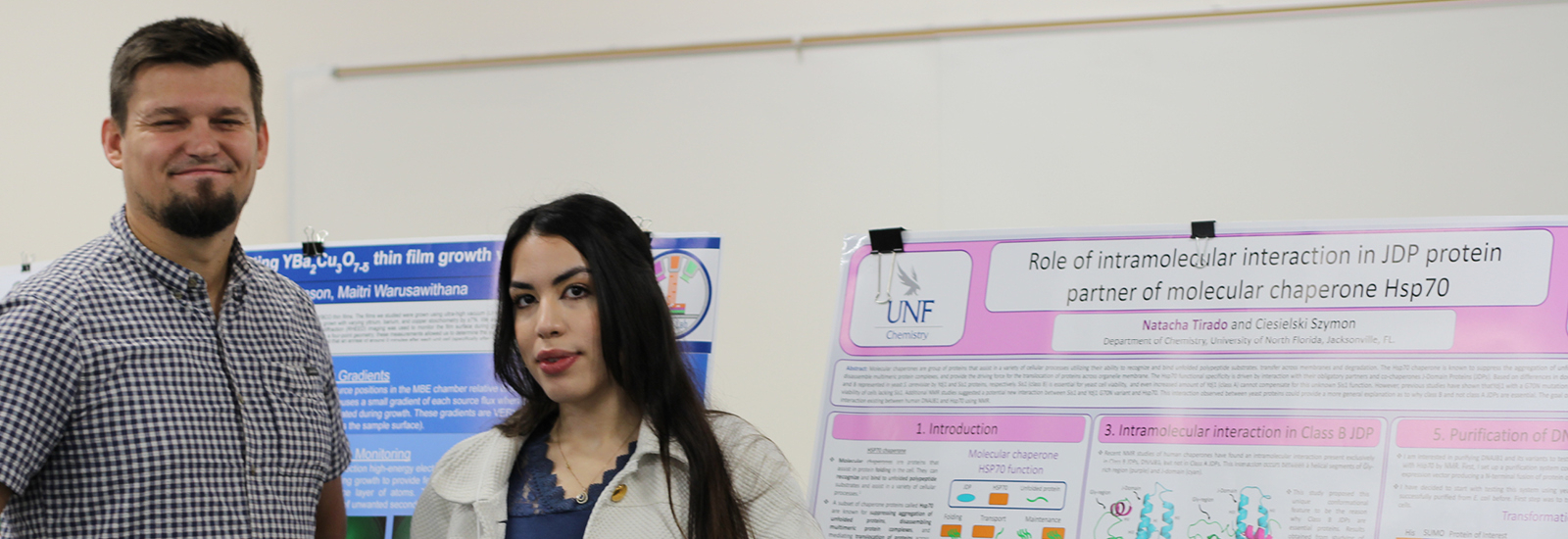 U-GLIDE Professor and Student posing in front of poster