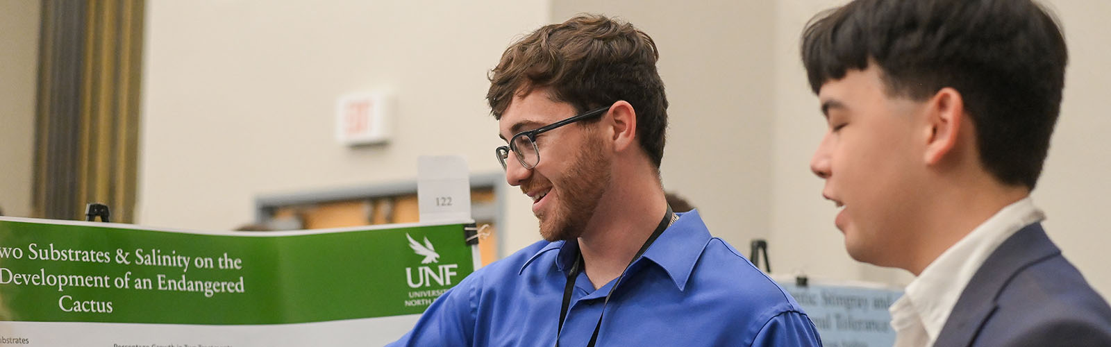 student explaining the poster to a interested person