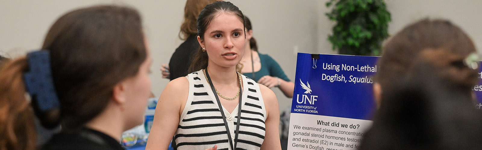 student discussing her research at a conference