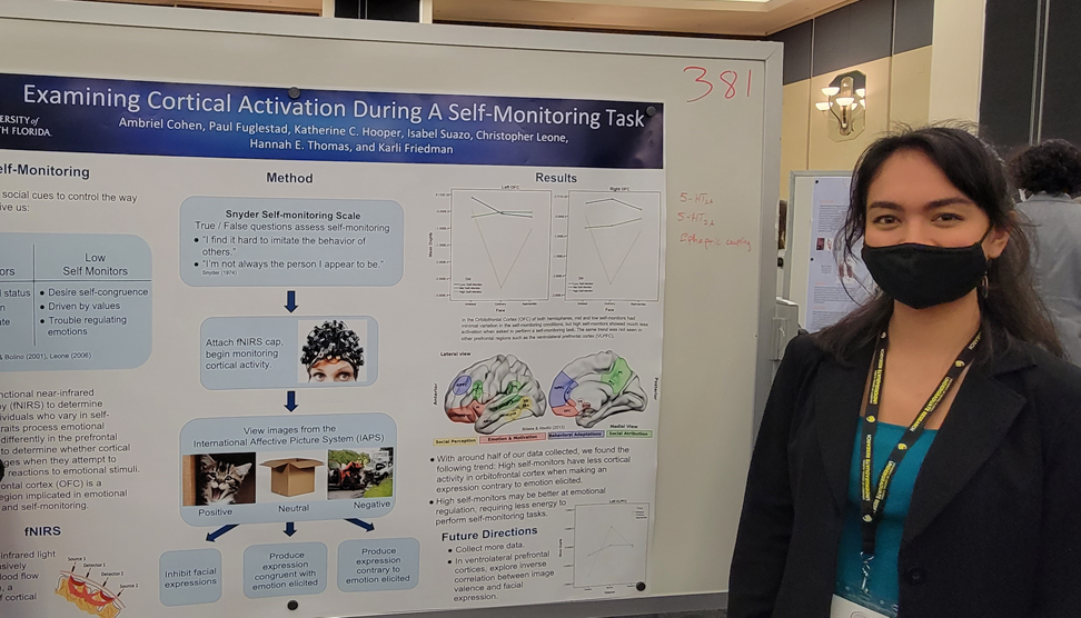hannah thomas in front of a board with her research