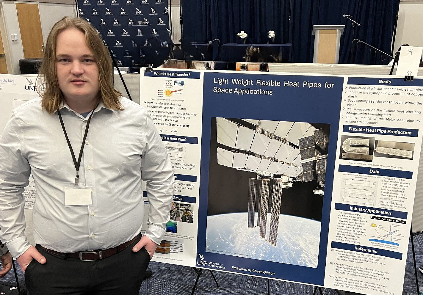 Chase Gibson standing in front of his research poster.