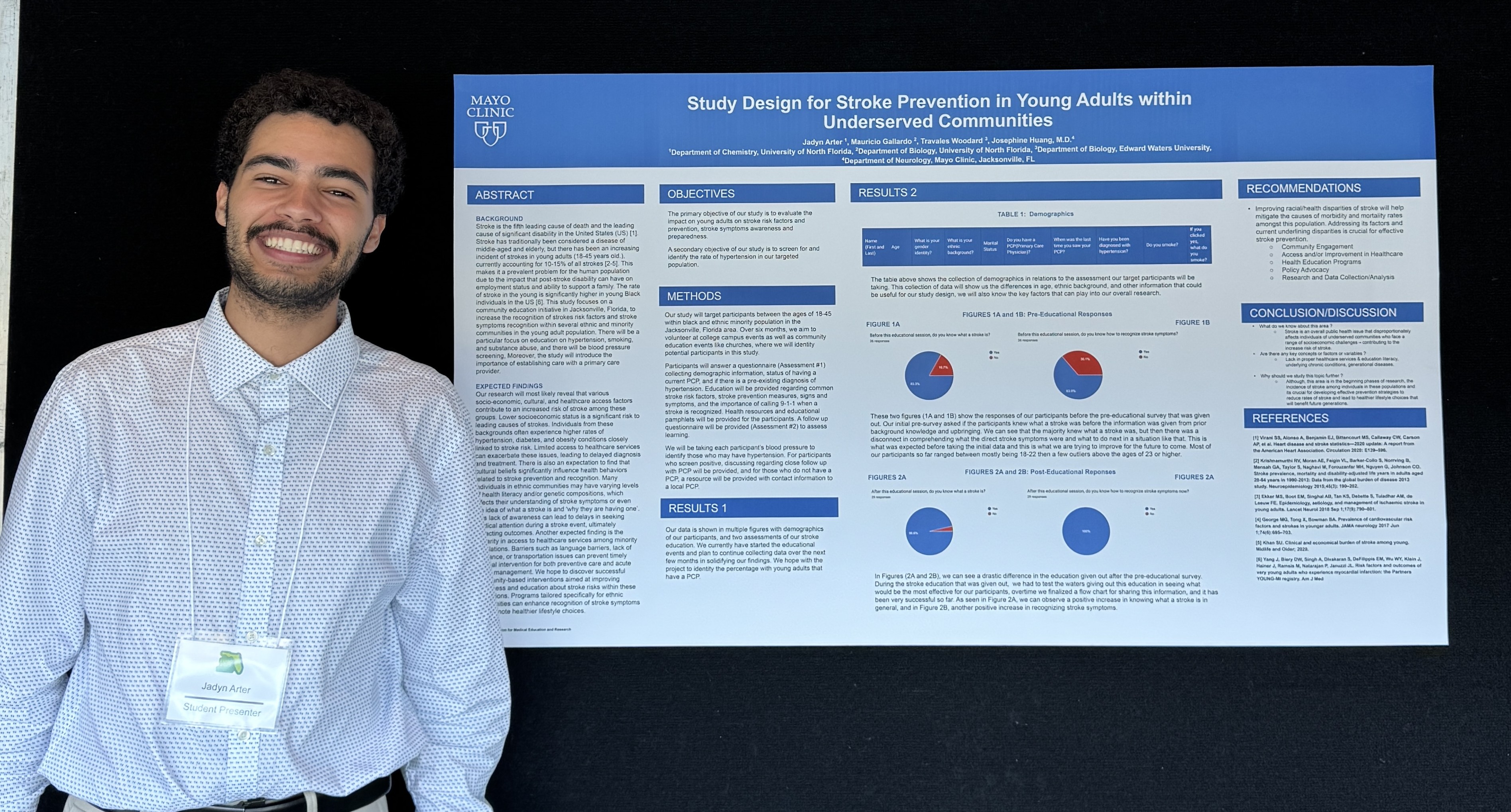 Jadyn is standing with his research poster